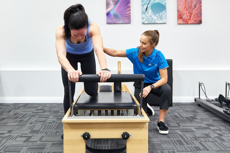 Woman using an exercise machine for her running physio appointment