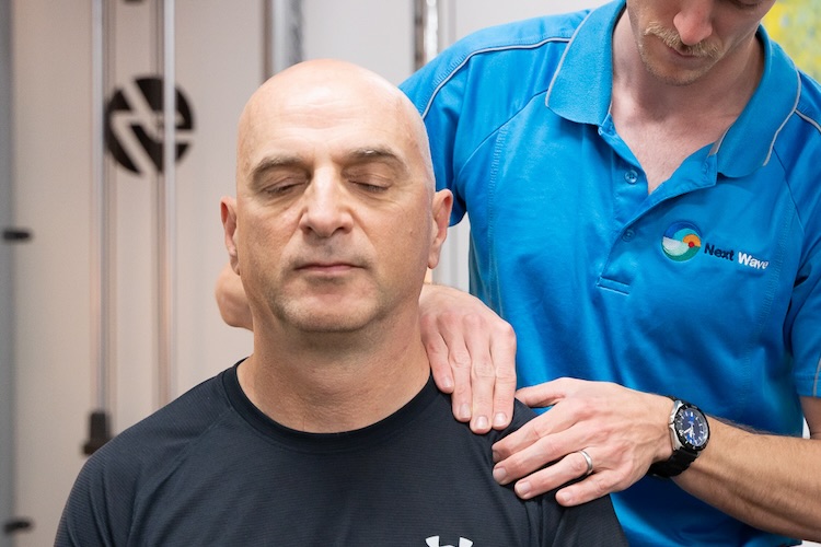 Man receiving manual therapy during his appointment for neck physio in Perth